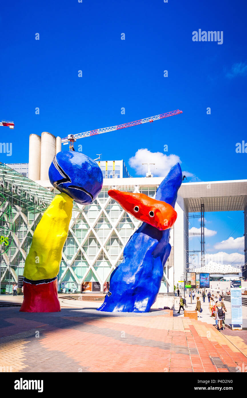 "Personnages Fantastiques" is a colourful outdoor artwork and represent two dancers playing together amongst the high-rises at La Defense,Paris, Stock Photo