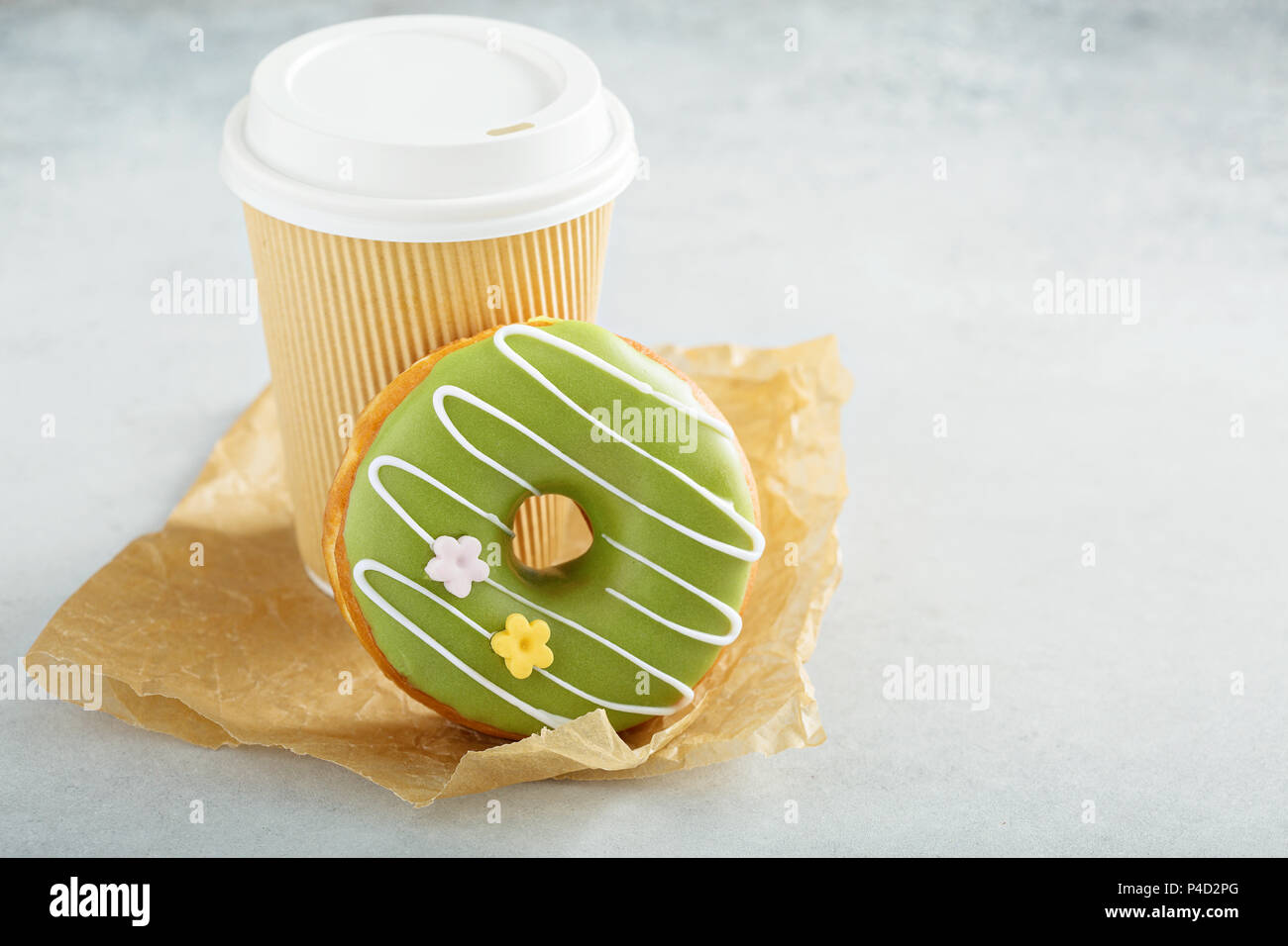 Green matcha glazed donut with cherry Stock Photo