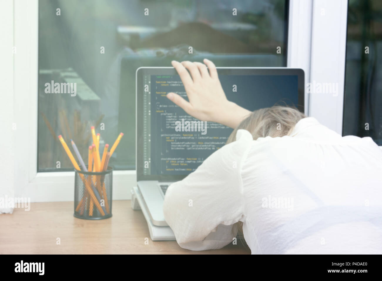 woman freelance programmer working from home. website code on screen ...