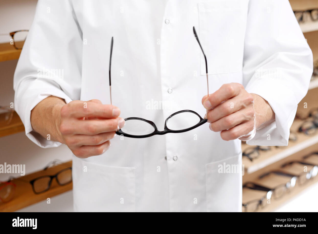 Optometrists. Optometrist chooses eyeglass frames in the optical salon