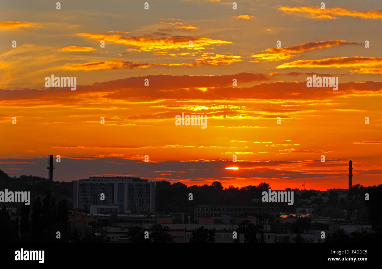 Warm sunset clouds over city. Kielce, Poland, Holy Cross Mountains. Stock Photo