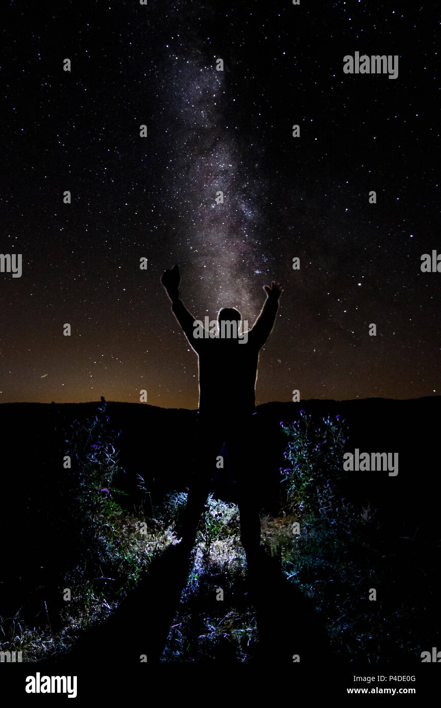 Night photography of the Milky way with human figure at Camprodon valley, Girona, Catalonia. Stock Photo