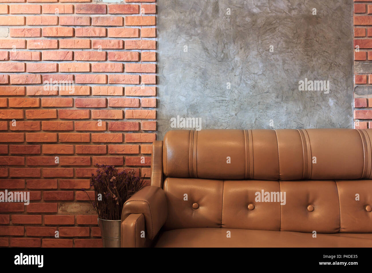 Vintage room with sofa set brick wall background, in the cafe. Stock Photo