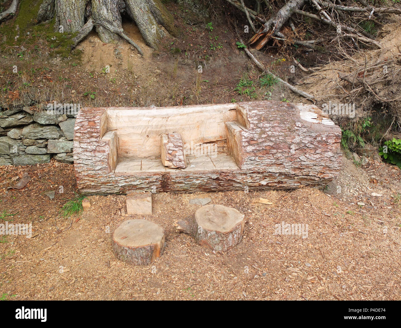 Dunkeld, Scotland, UK - August 16, 2013: Some garden carvings from an old tree trunk that have been thoughtfully carved out of fallen trees within the Stock Photo