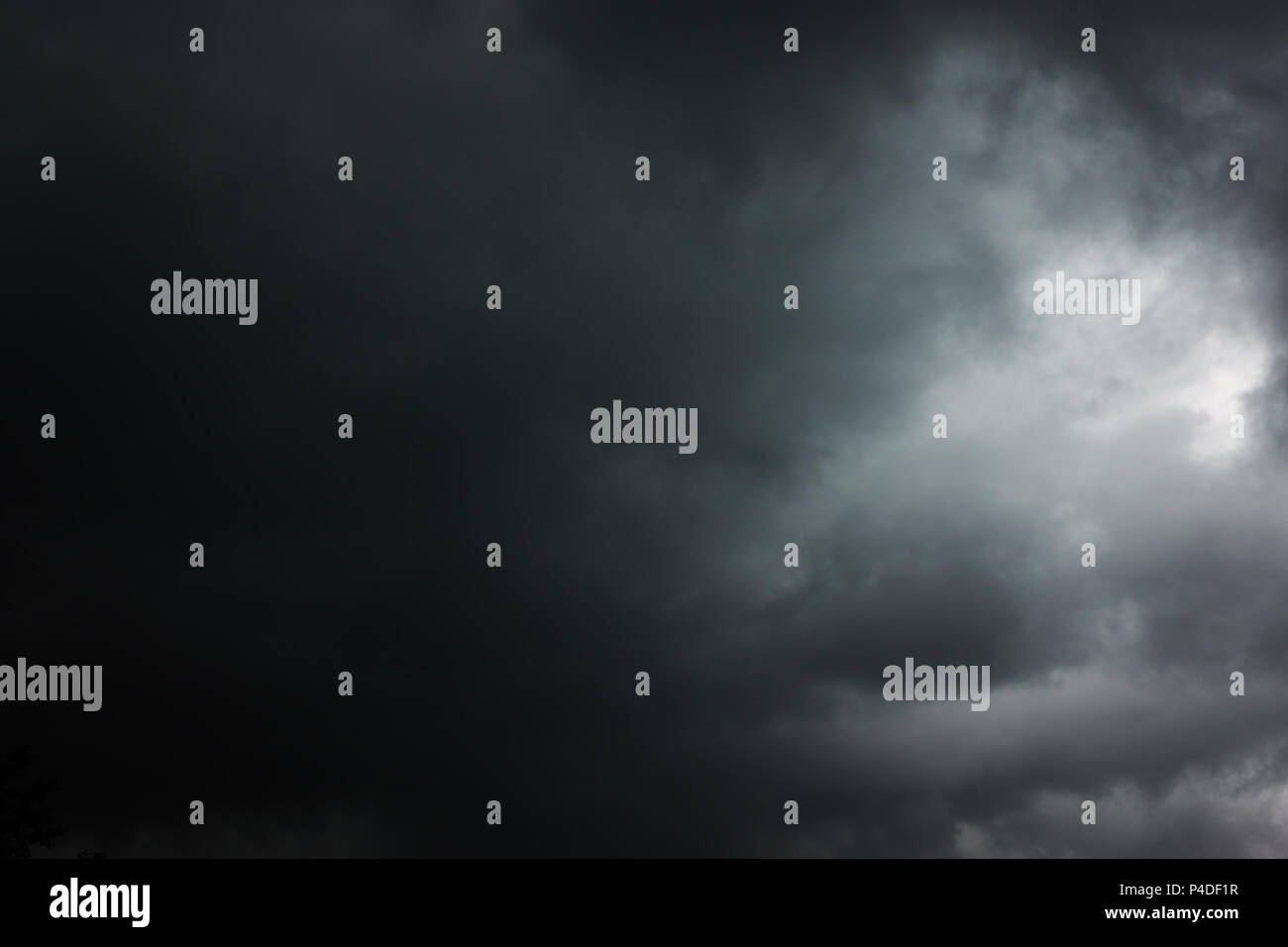 Black heavy clouds with hole, may be used as background - Dramatic sky Stock Photo