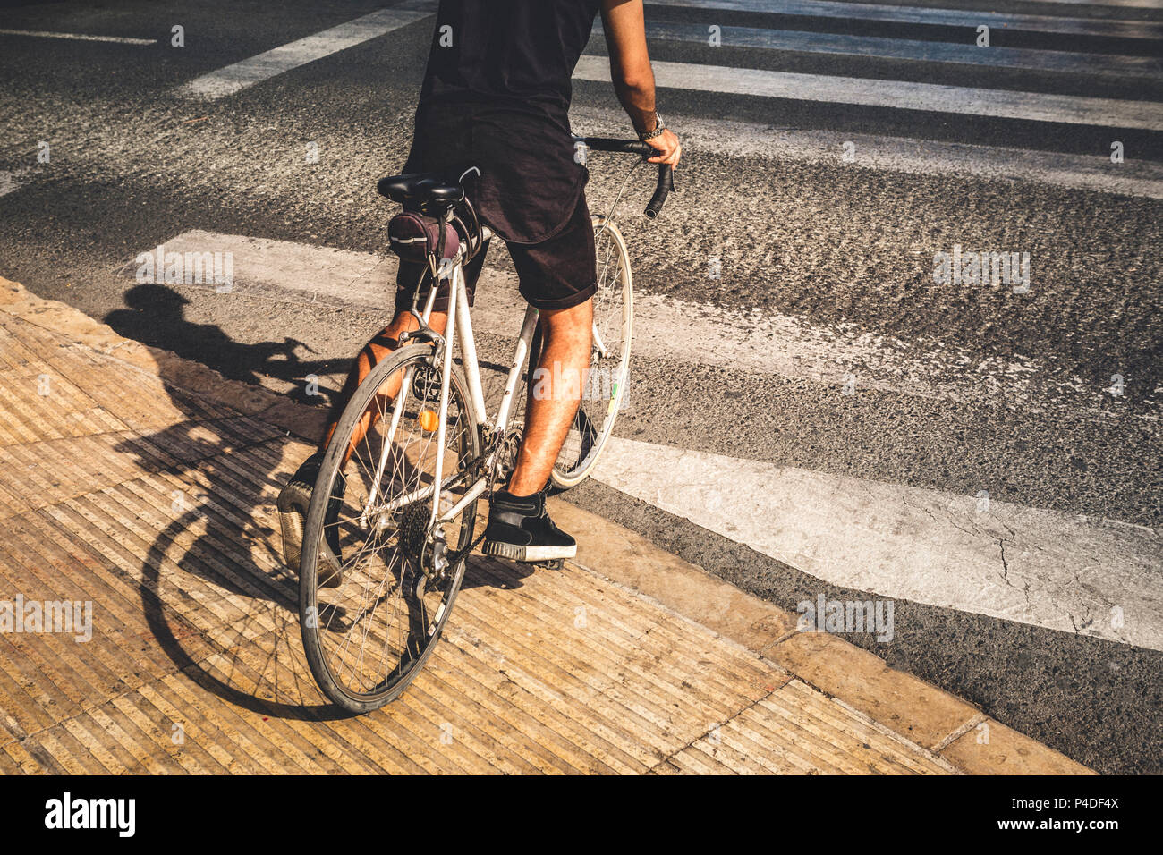 Guy riding a road bike in the city at sunset Stock Photo Alamy
