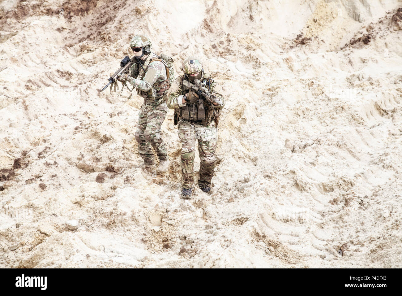 Infantrymen ready for fight moving in desert Stock Photo
