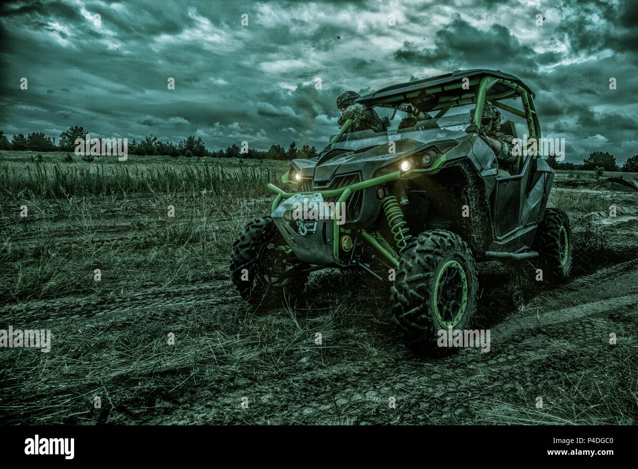 Army rangers moving on military buggy at night Stock Photo