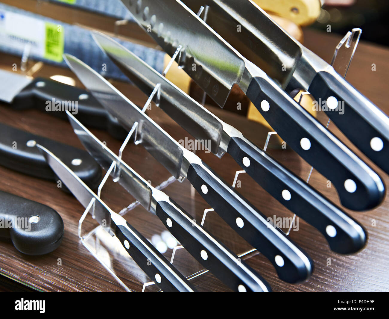 Kitchen knives on a stand on a shelf in the store Stock Photo