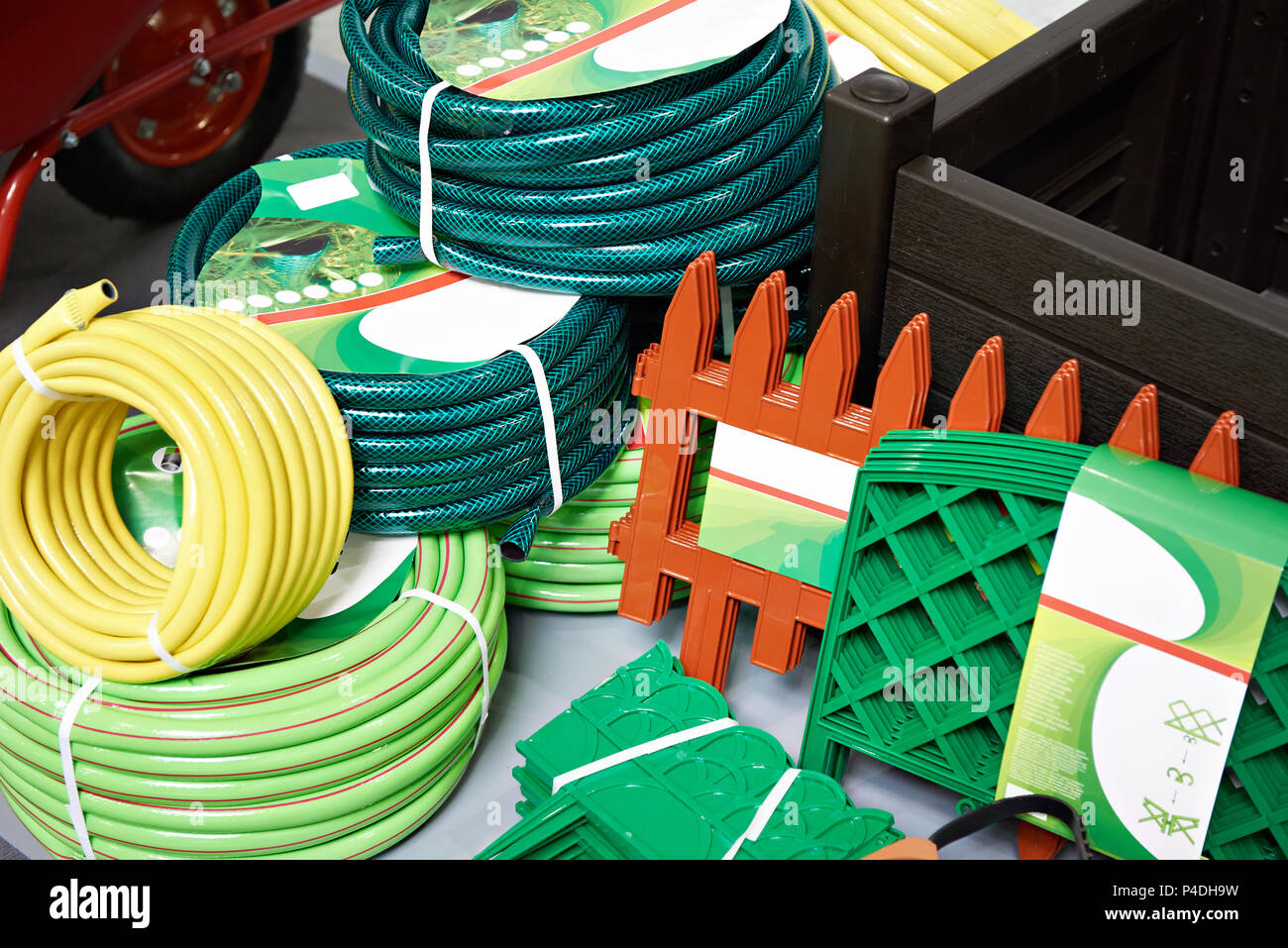 Garden hoses and a fence in a household goods store Stock Photo