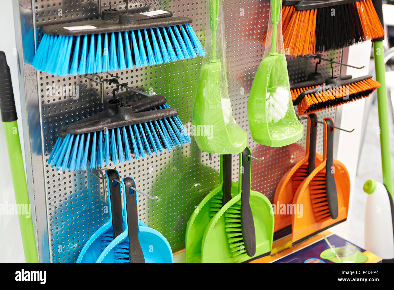 Plastic household brushes and scoops in the hardware store Stock Photo