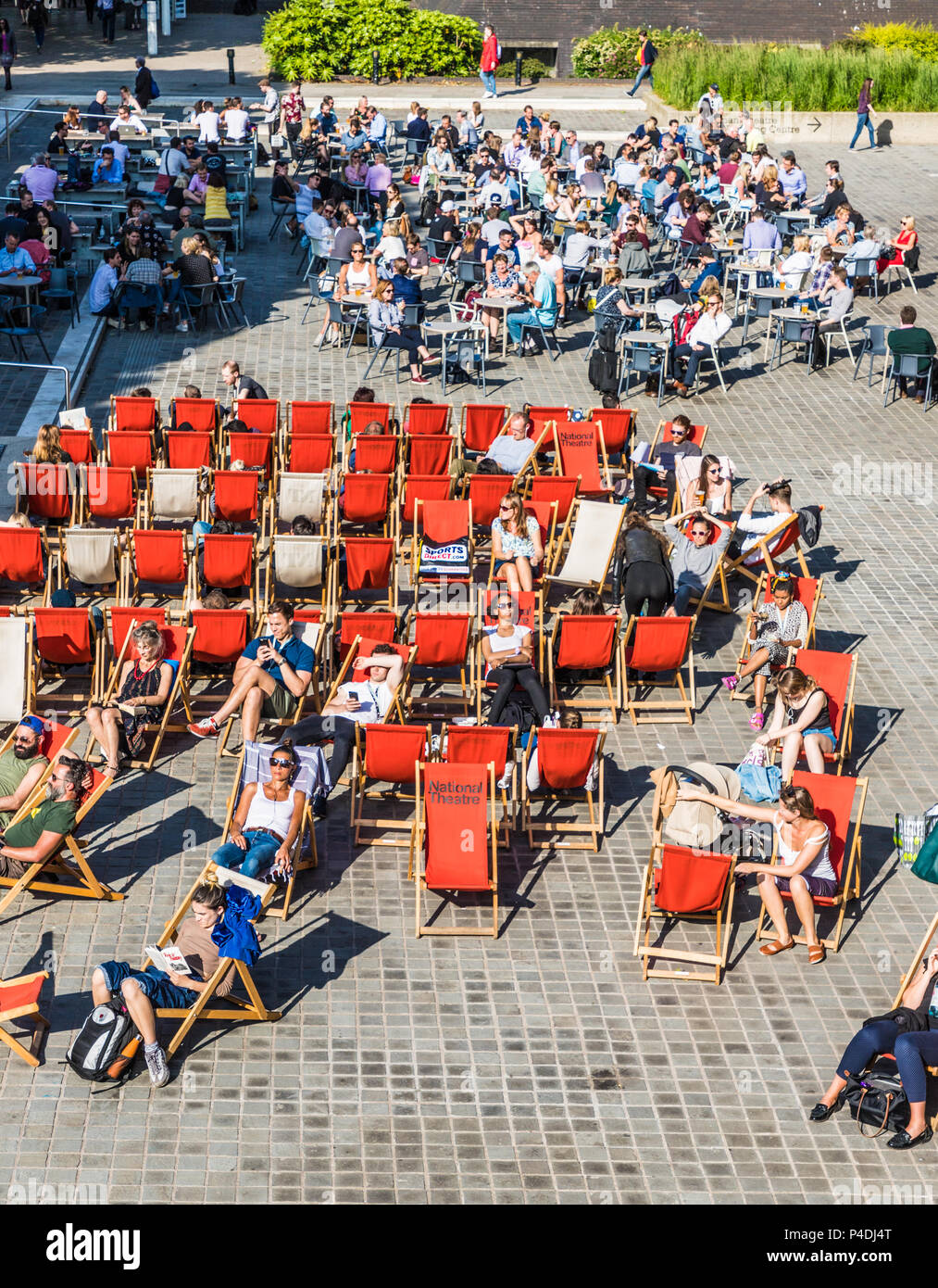 London. June 2018. A view of people relaxing outside the national Theatre along the south bank in London Stock Photo