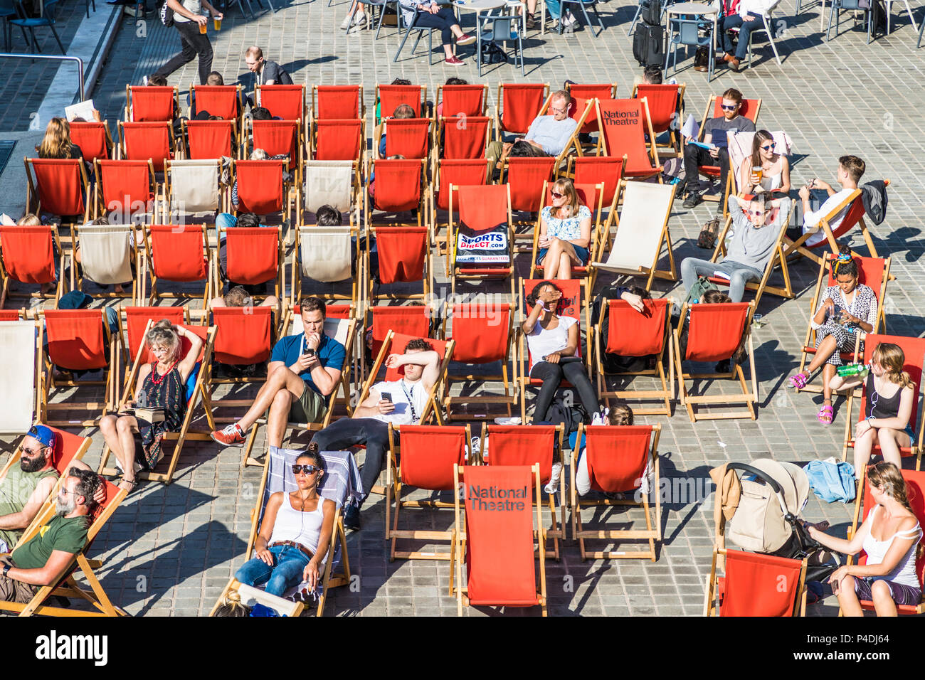 London. June 2018. A view of people relaxing outside the national Theatre along the south bank in London Stock Photo
