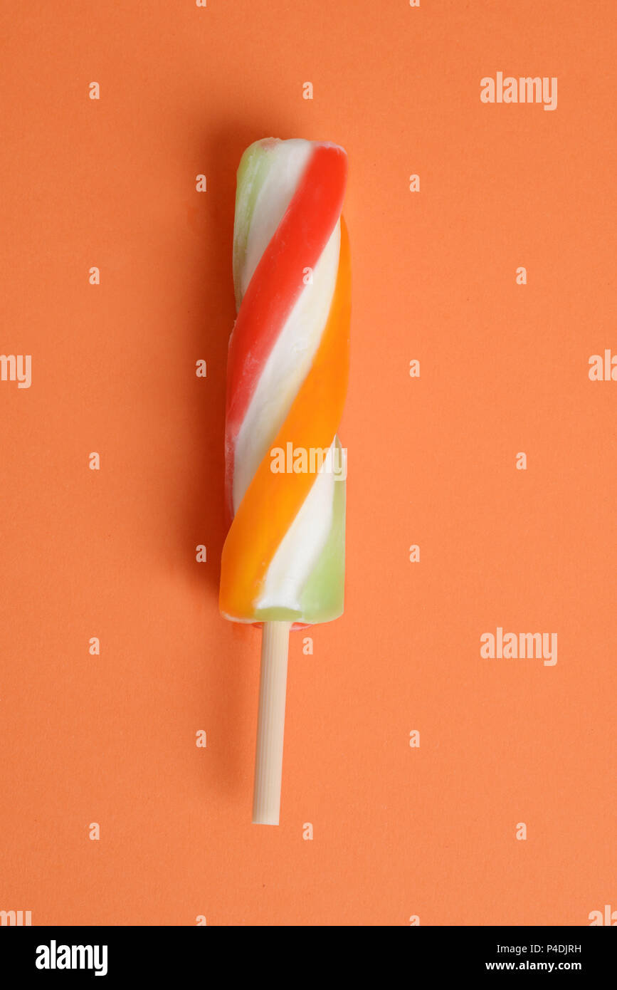swirl popsicle on orange paper background Stock Photo