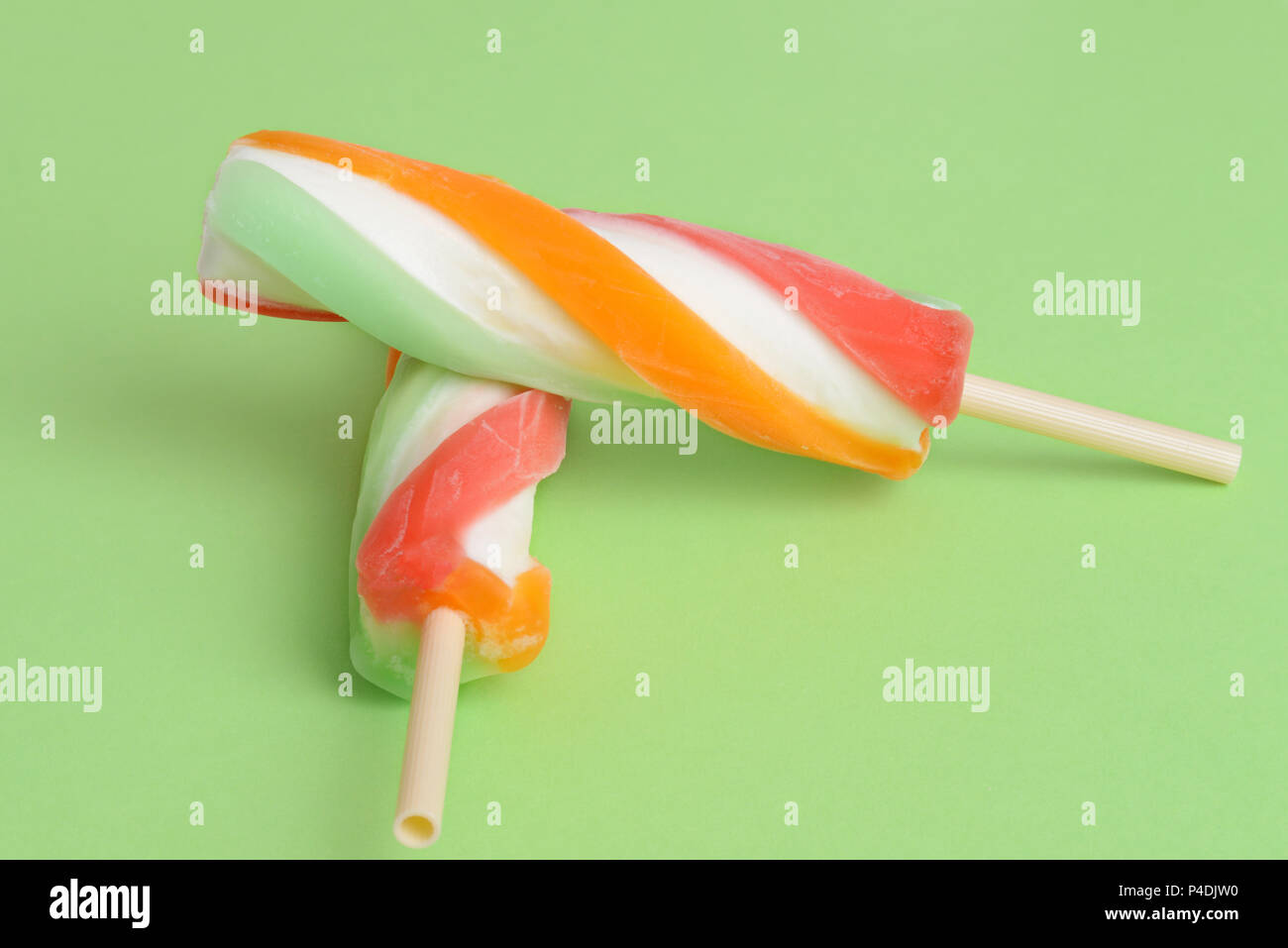 two swirl popsicle on green background Stock Photo