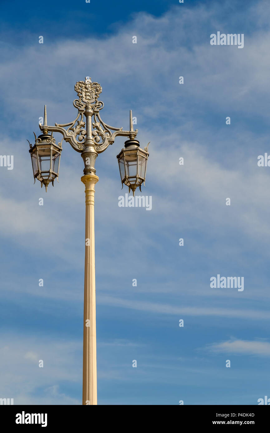 Ornate street lamp on the seafront in the city of Brighton, East Sussex, England, UK in portrait orientation. Stock Photo