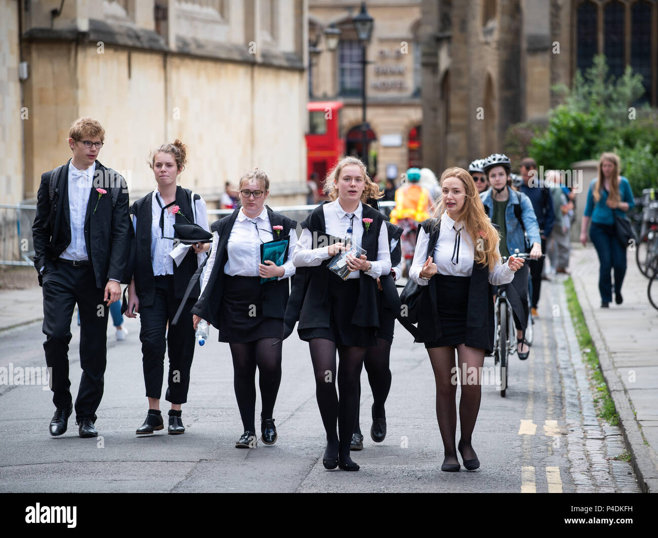 Students at Oxford University wearing tradional 'sub fusc' garments which are compulsory when taking exams. Carnations denote course year. Stock Photo