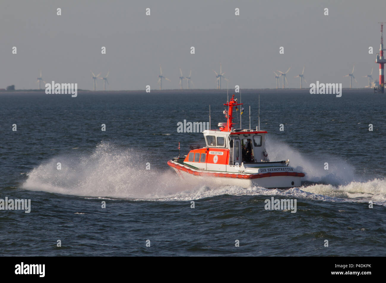 A small white and orange pilot vessel underway in Germany Stock Photo