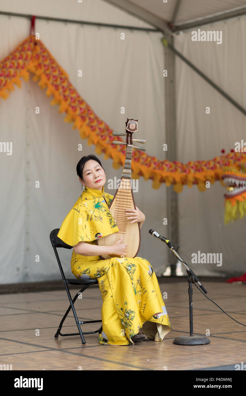 Columbus, Ohio, USA - May 27, 2018 A member of the Hefei Artists Group plays the pipa at the Asian Festival. Stock Photo