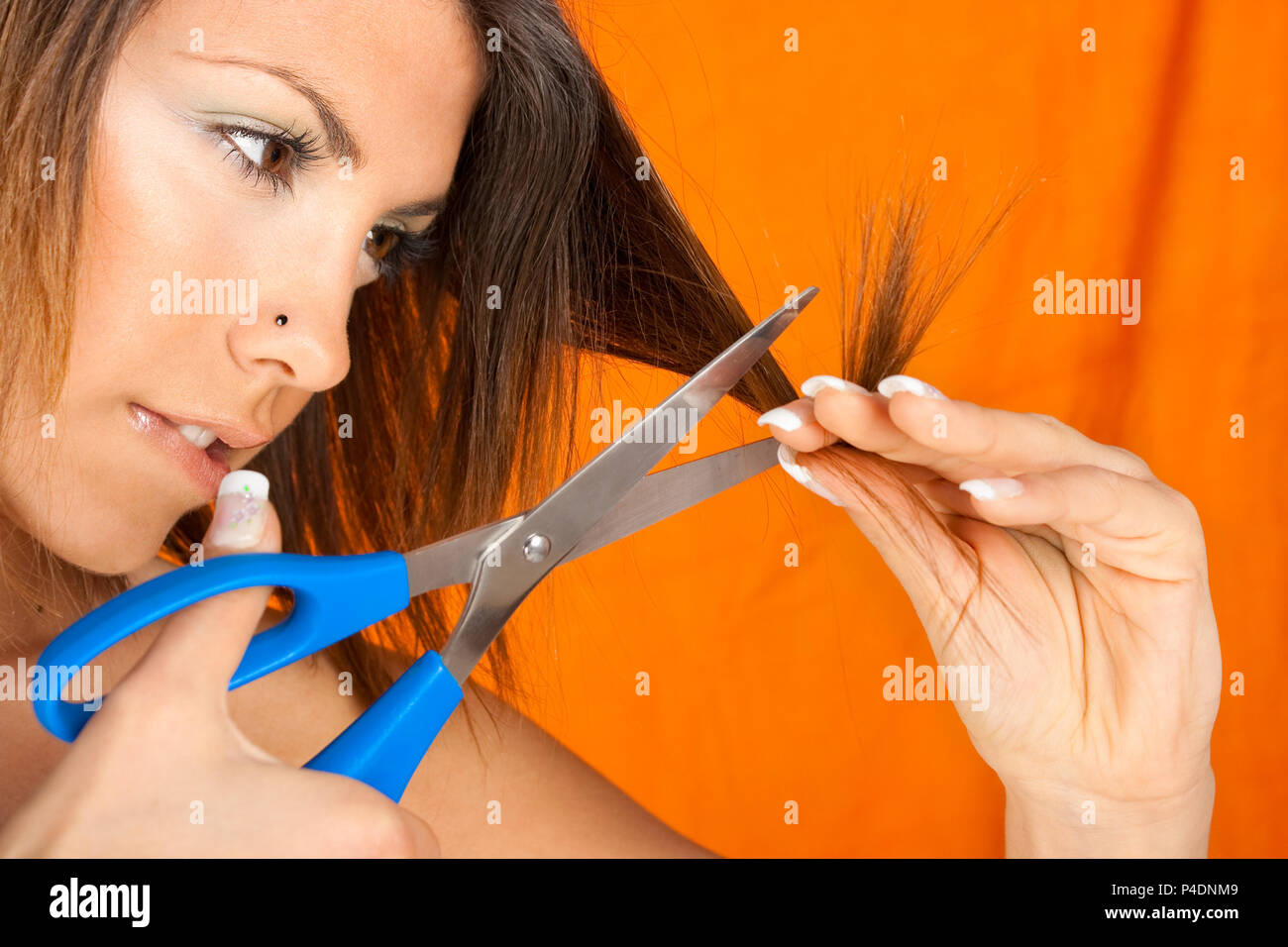 Young beautiful girl cutting her hair, closeup Stock Photo Alamy