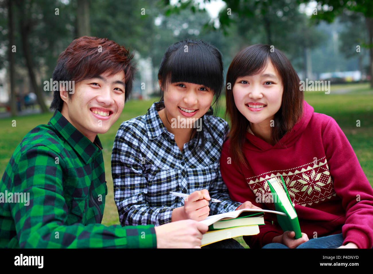 three asian college students study together in campus Stock Photo