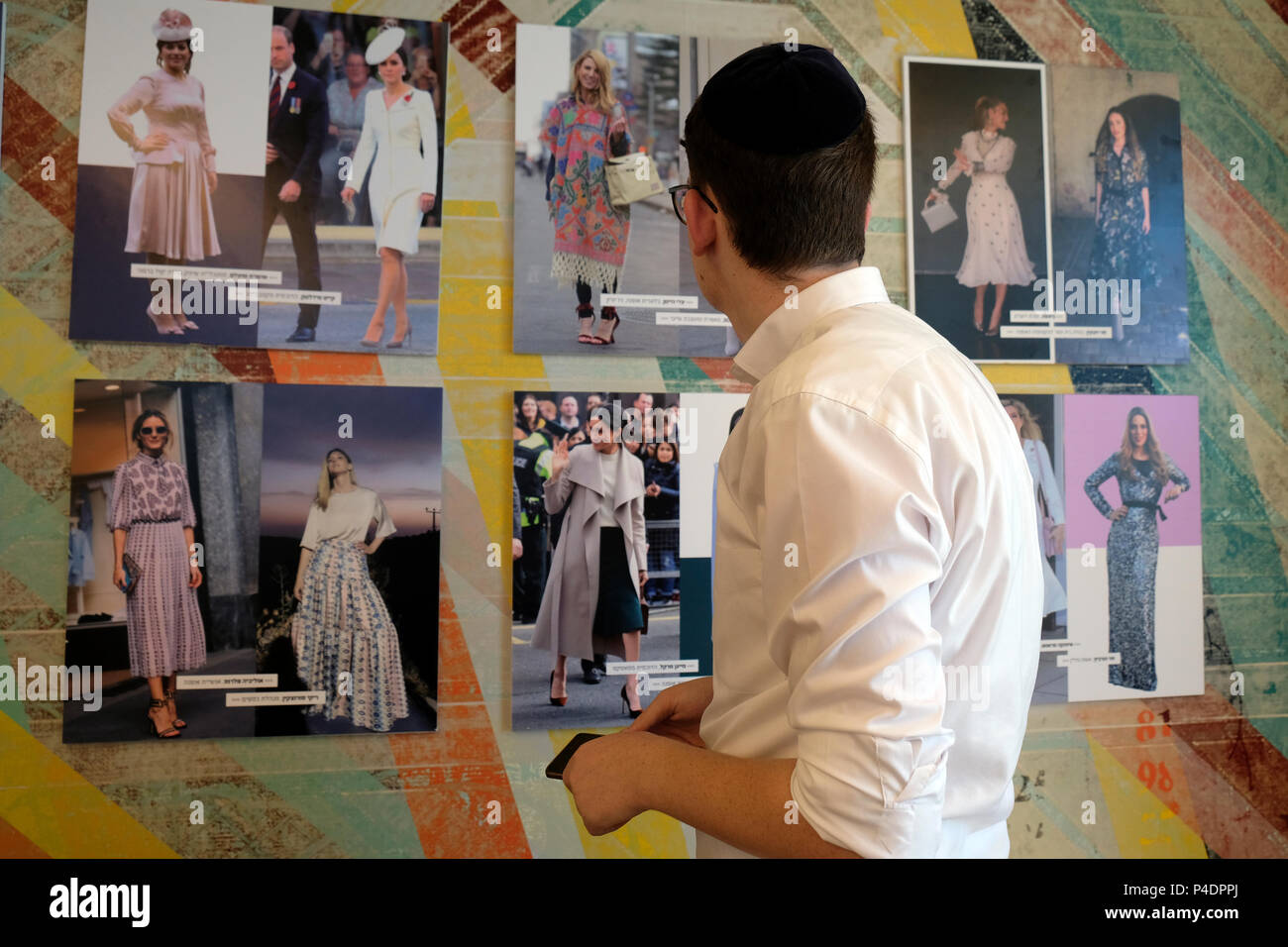An ultra orthodox Jew looking at magazine tear sheets with photos of celebrity figures and Haredi women wearing fashionable clothing hanged  at the only school for fashion and styling professions in the Haredi sector which Miri Beilin a Haredi Designer and Stylist opened in the city of Bnei Brak or Bene Beraq a center of Haredi Judaism in Israel Stock Photo