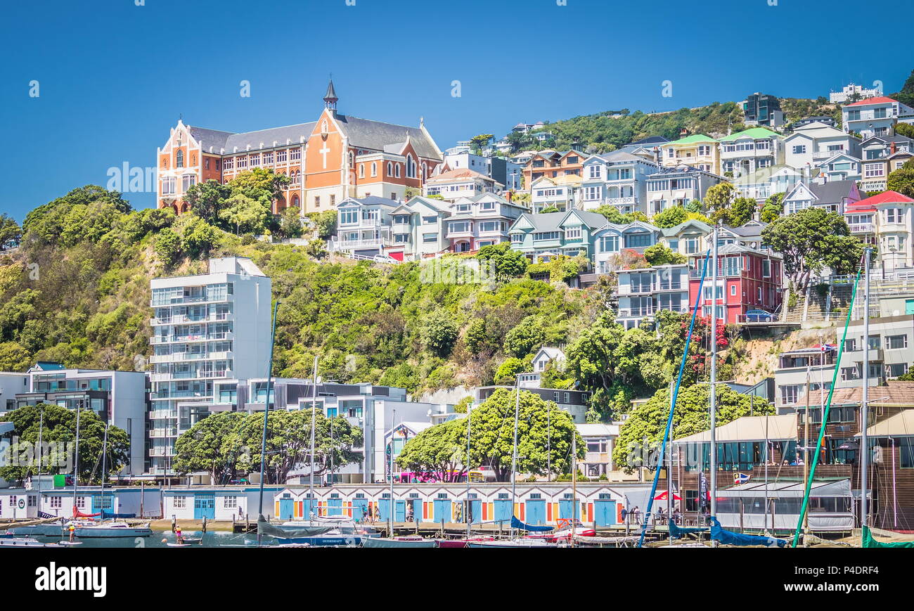 Wellington, New Zealand - 13 February  2016: Oriental Parade boatsheds nestled below the iconic St Gerard's Monastery, one of the city's most recogniz Stock Photo