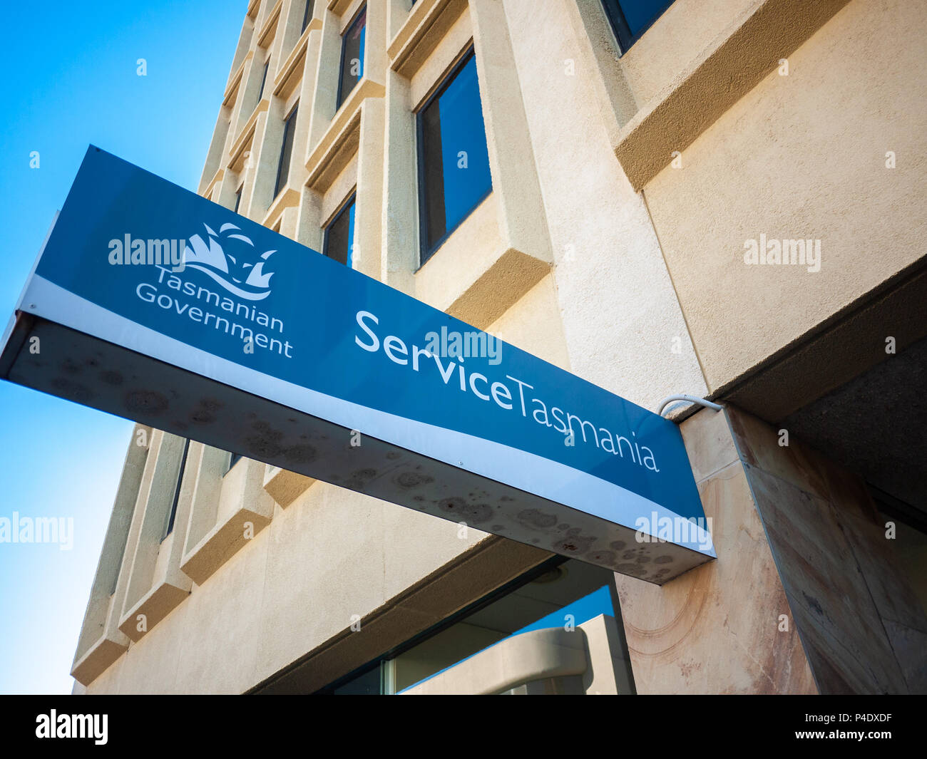 Sign of Service Tasmania attached to office building. Service Tasmania provides one-stop access to government transactions, services and information. Stock Photo