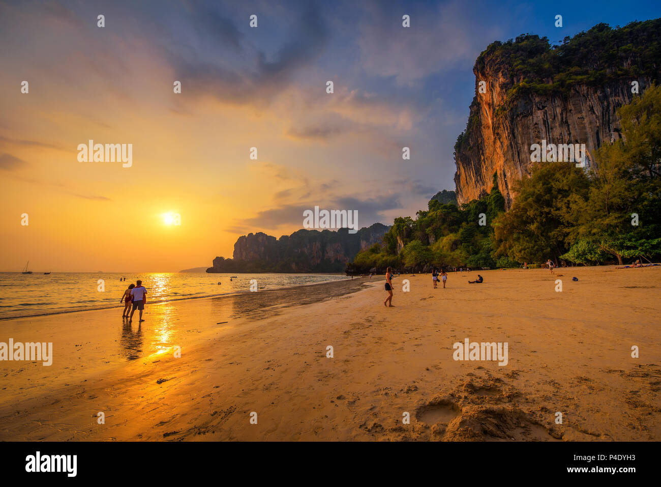 Tourists rest at the Railay Beach before sunset Stock Photo