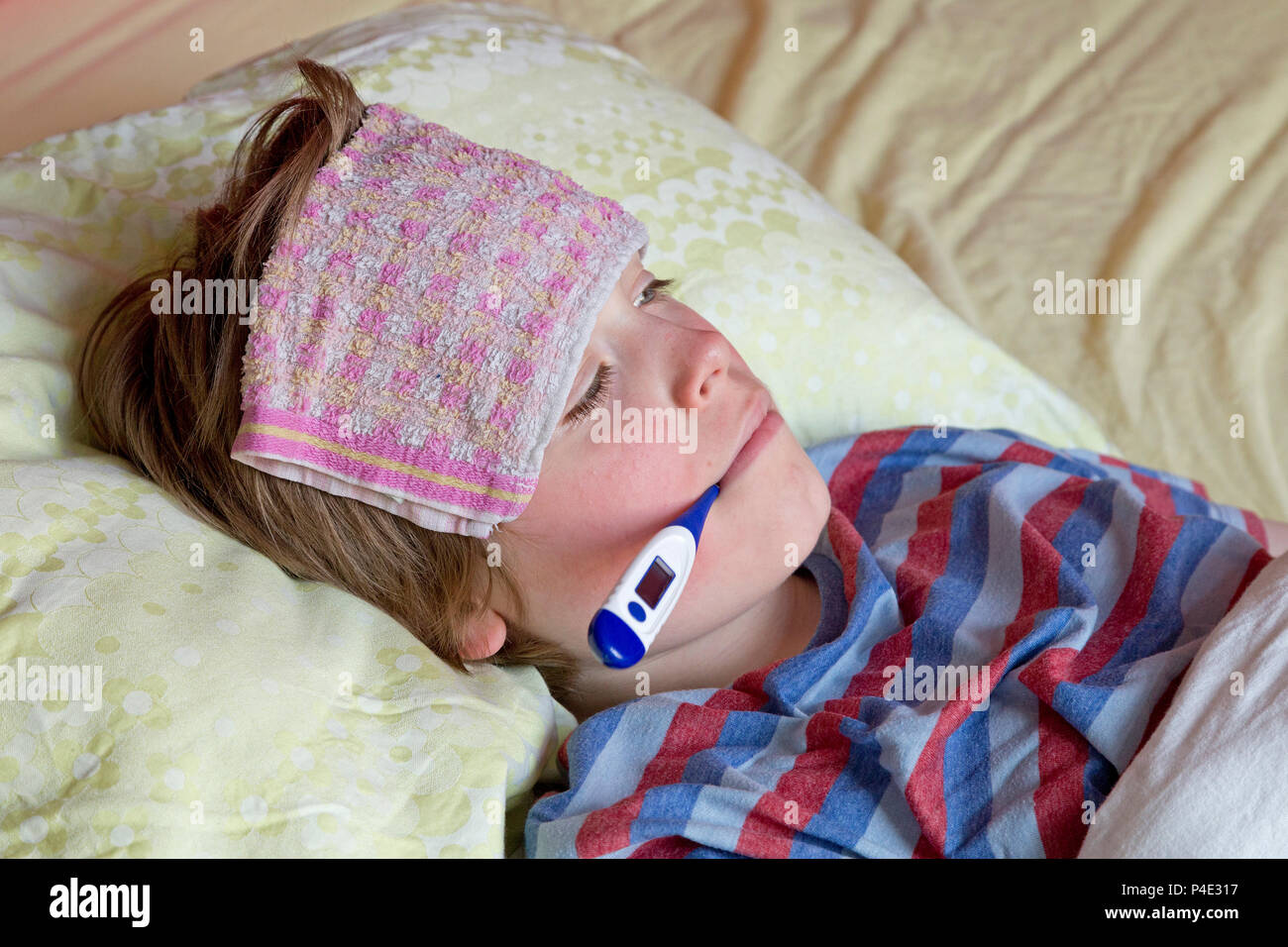 boy lying in bed ill Stock Photo