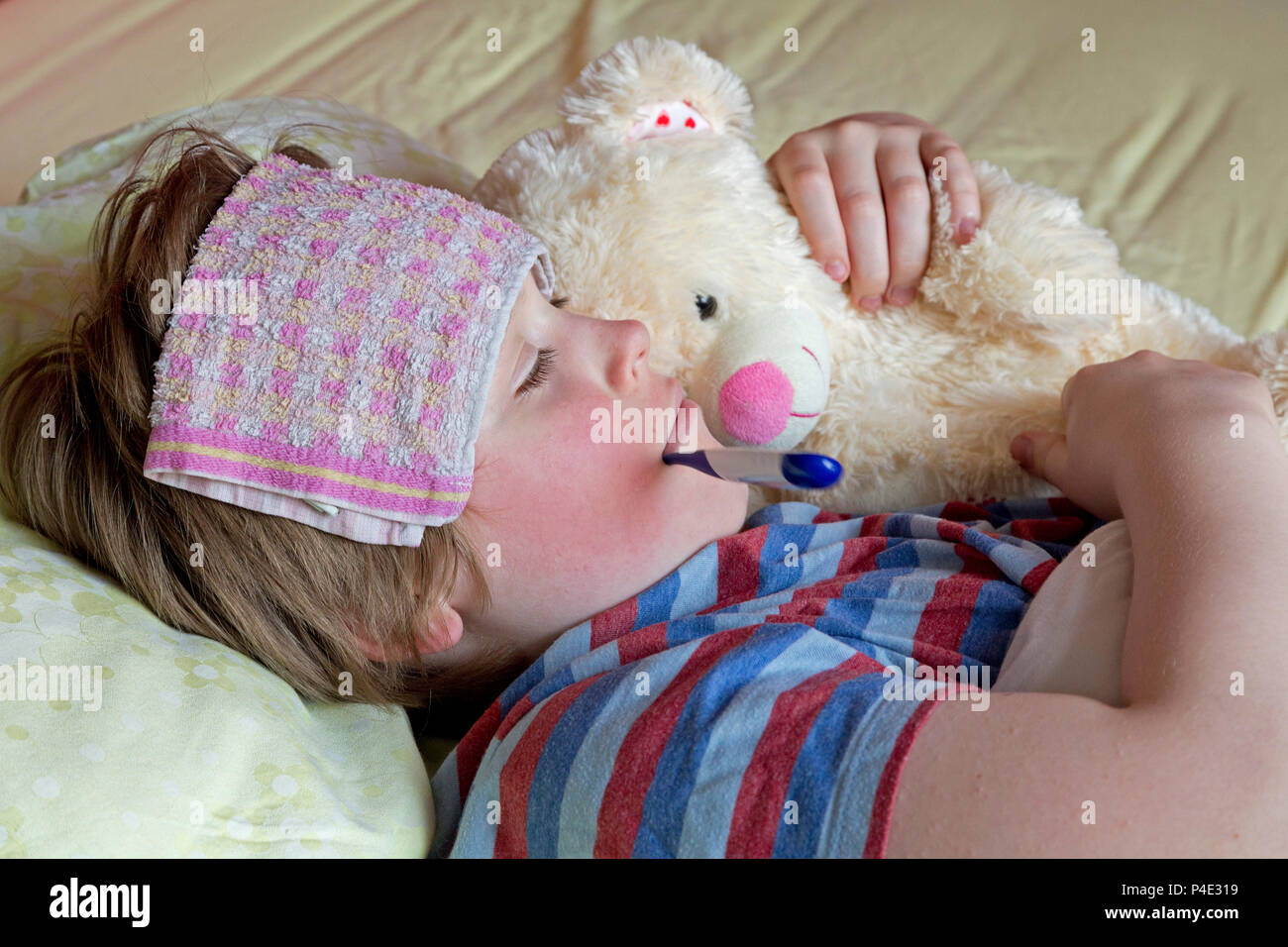 boy lying in bed ill Stock Photo