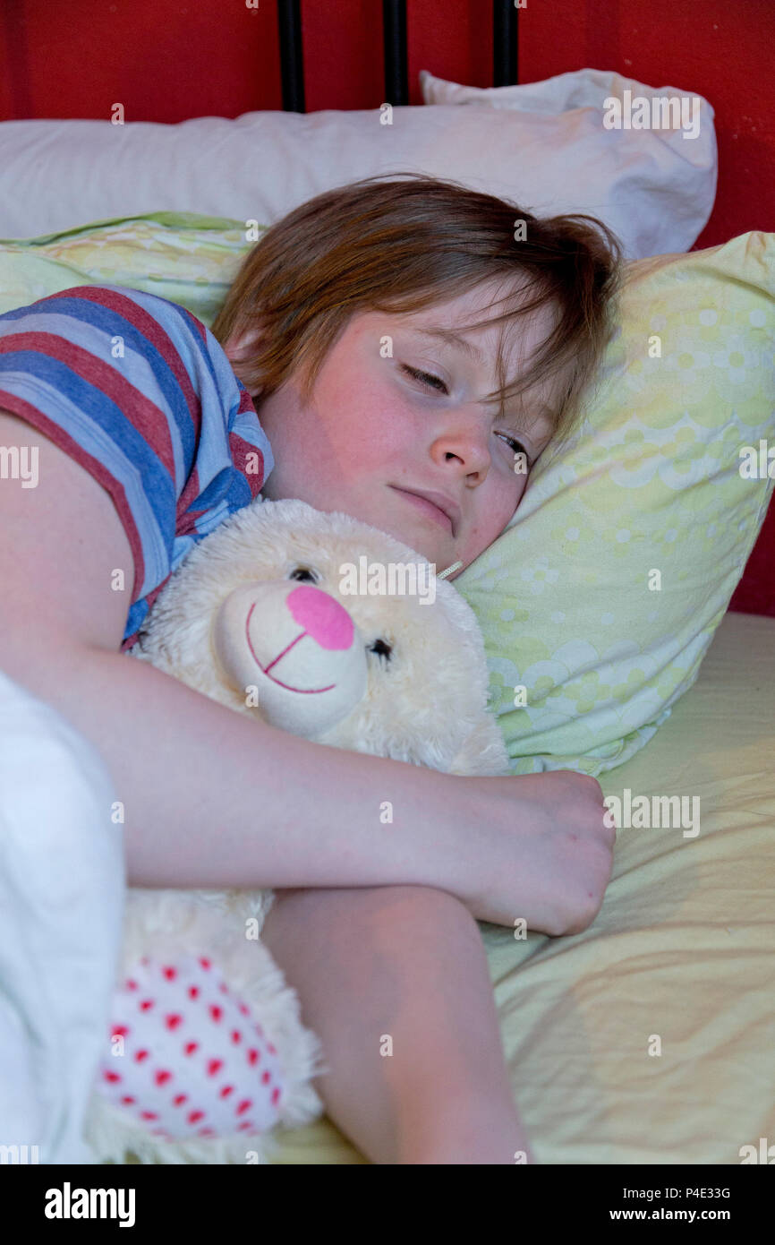boy lying in bed ill Stock Photo