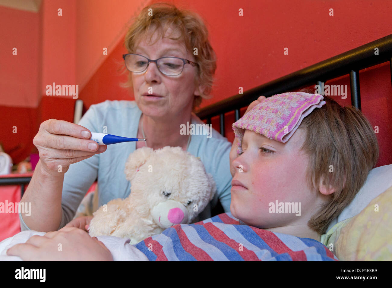 mother taking her son´s temperature Stock Photo