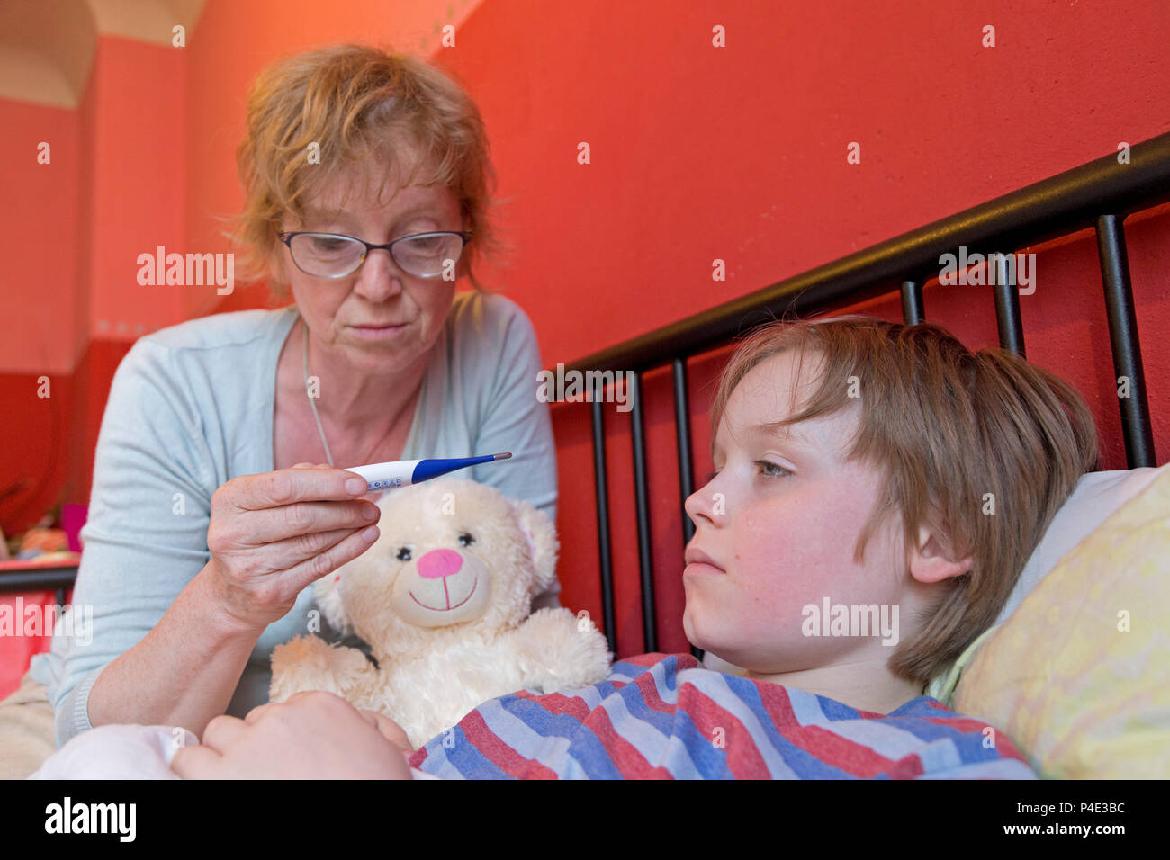 mother taking her son´s temperature Stock Photo