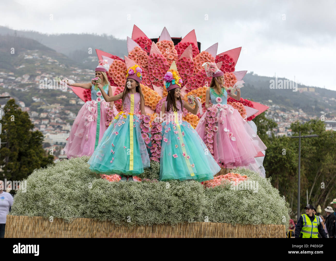 Funchal; Madeira; Portugal - April 22; 2018: Girls in colorful costumes on the floral float at Madeira Flower Festival Parade in Funchal on the Island Stock Photo