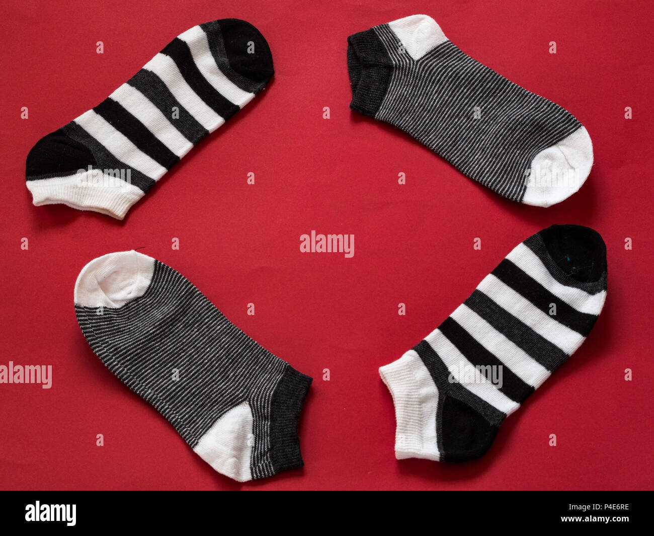 Black and white socks on red background with copy space Stock Photo - Alamy