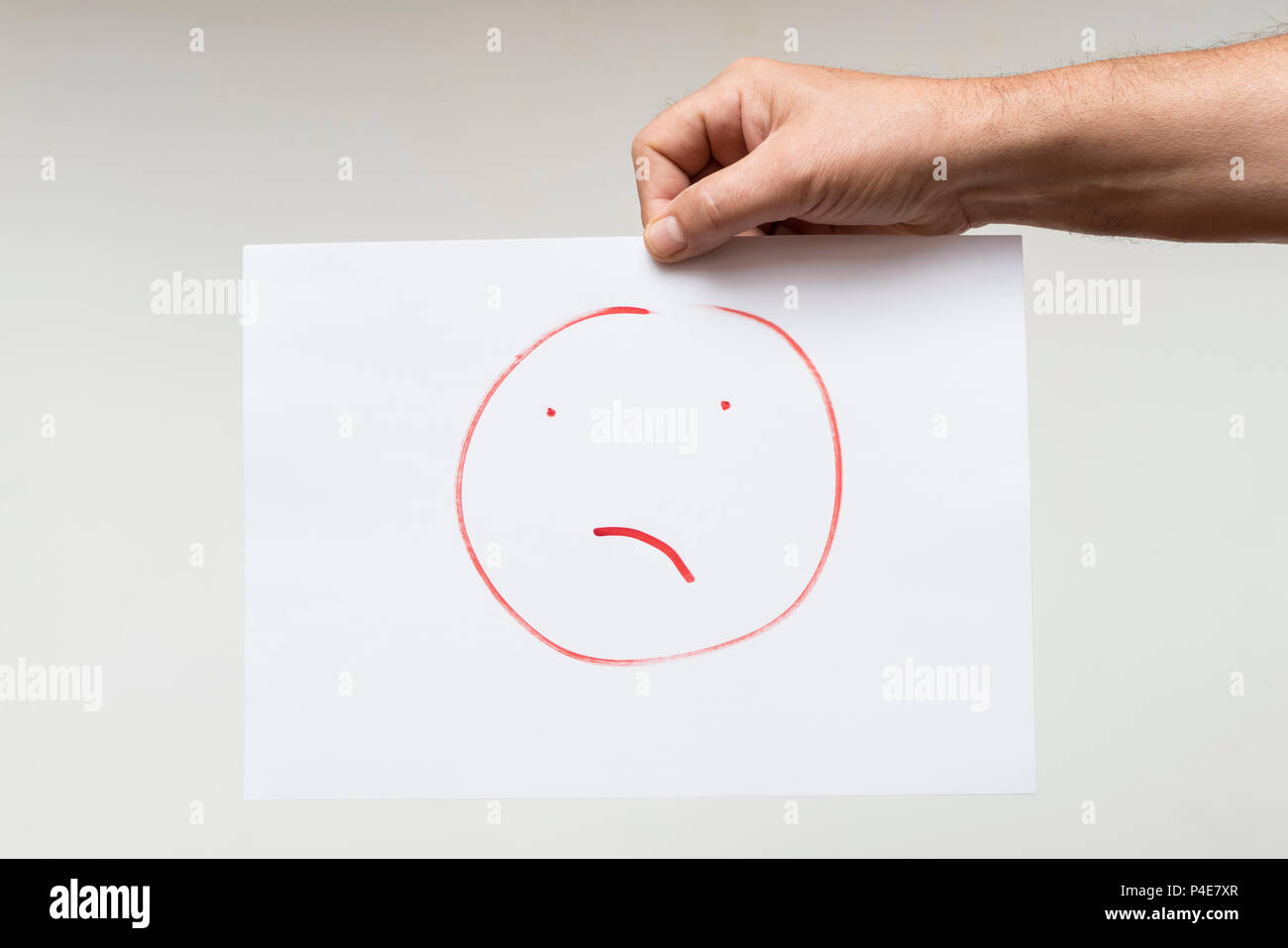 a sheet of paper with a drawn face disgusted Stock Photo