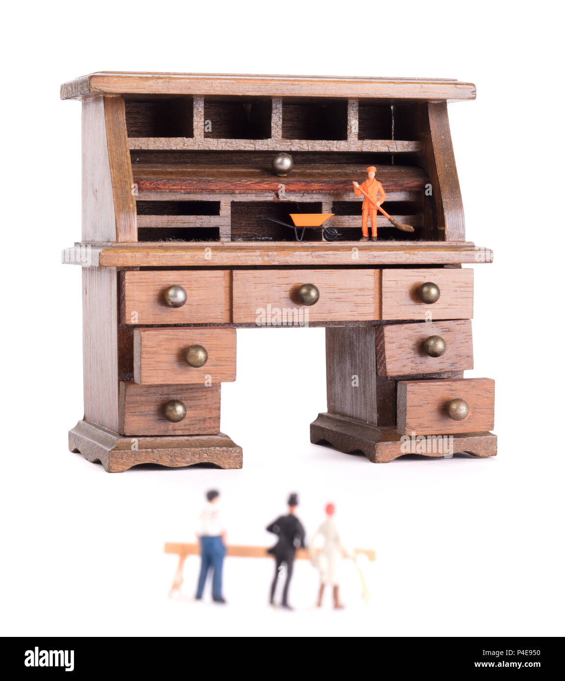 Small vintage wooden desk, small man cleaning Clean desk policy Stock