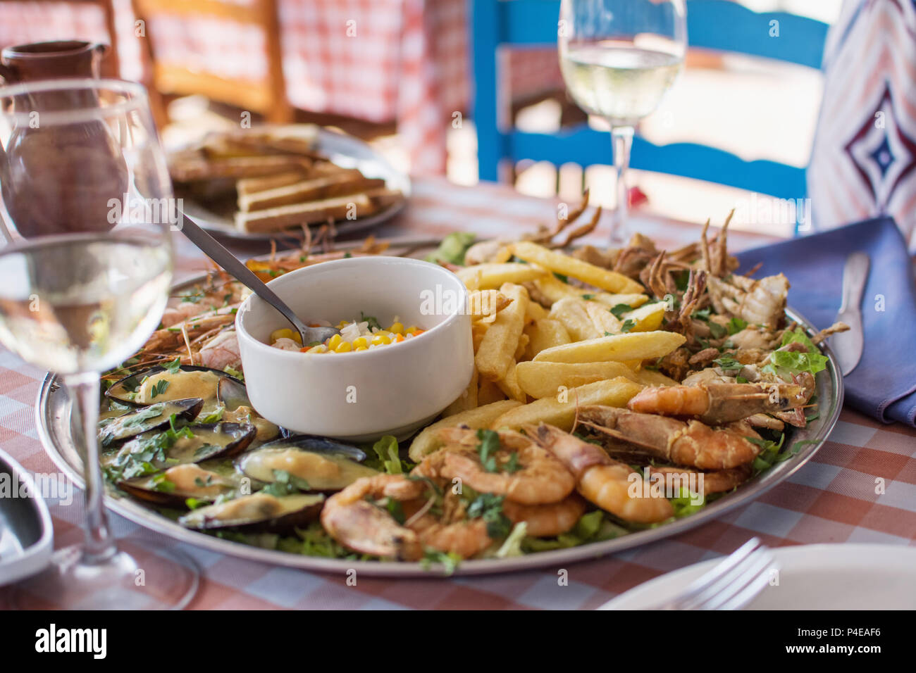 fried seafood - crab, shrimps, mussels with French fries and rice. Stock Photo