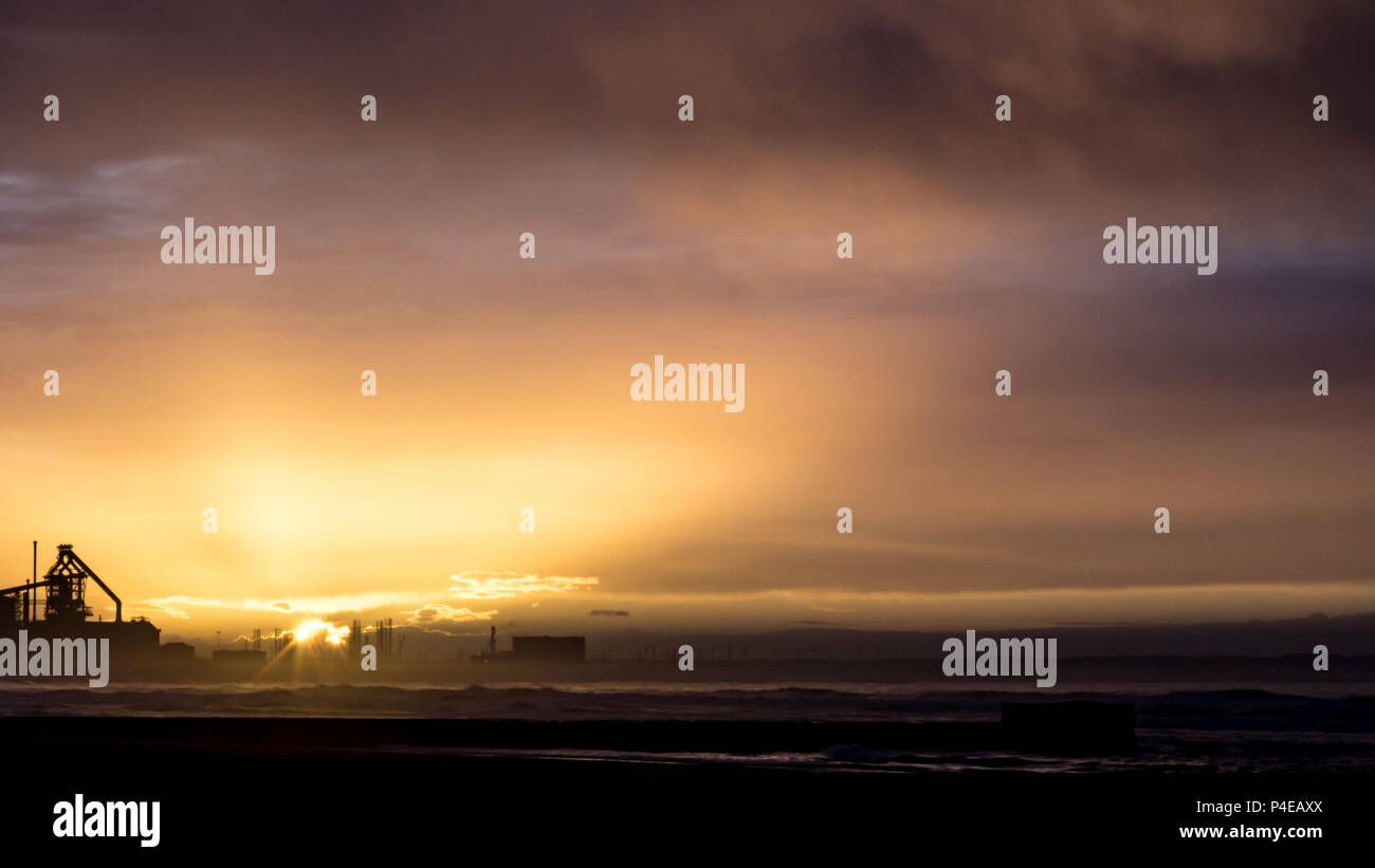 Redcar sunset with industrial background. Redcar is located on the north east coast of England. Stock Photo