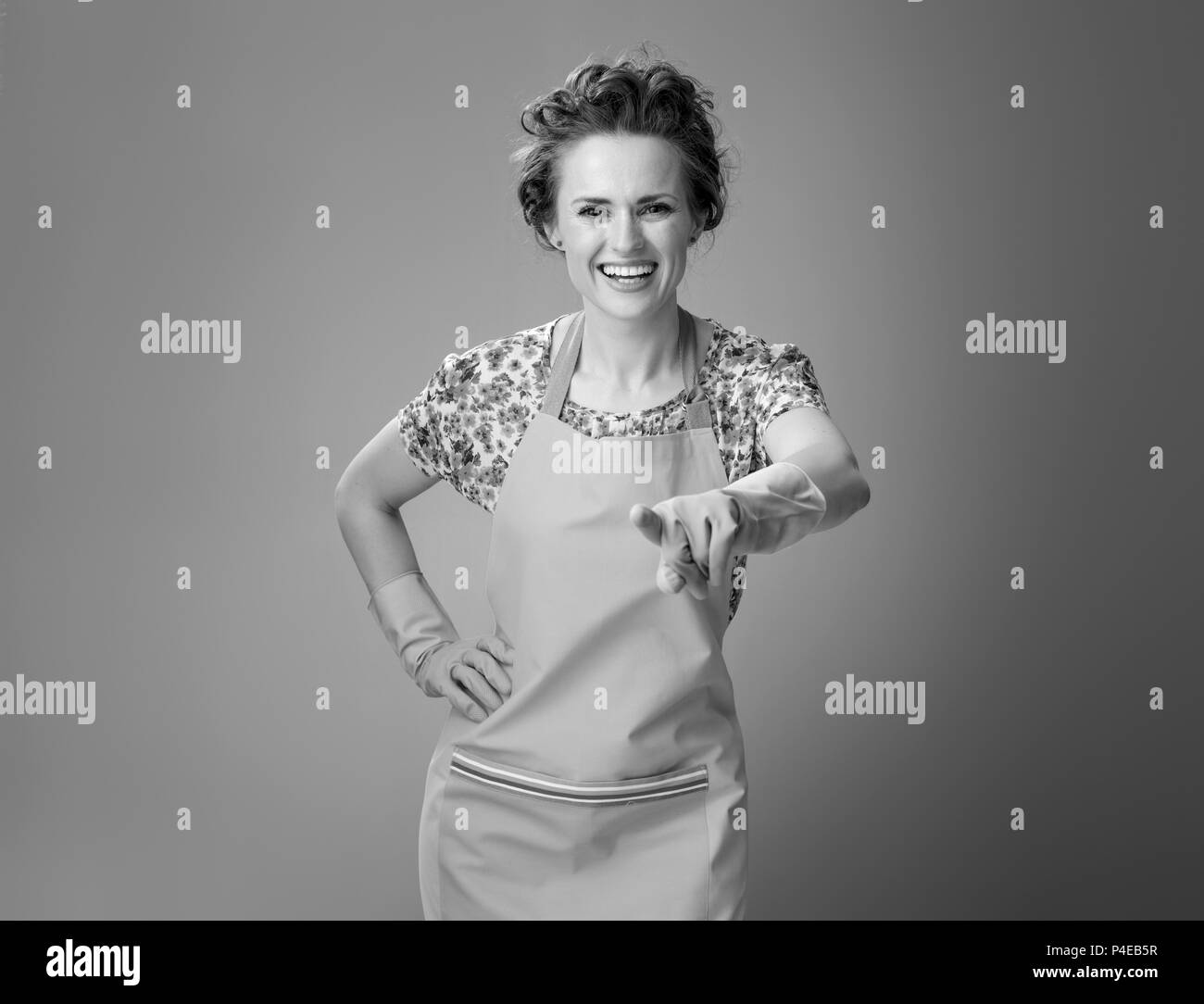 Big cleaning time. smiling modern woman with rubber gloves pointing in ...