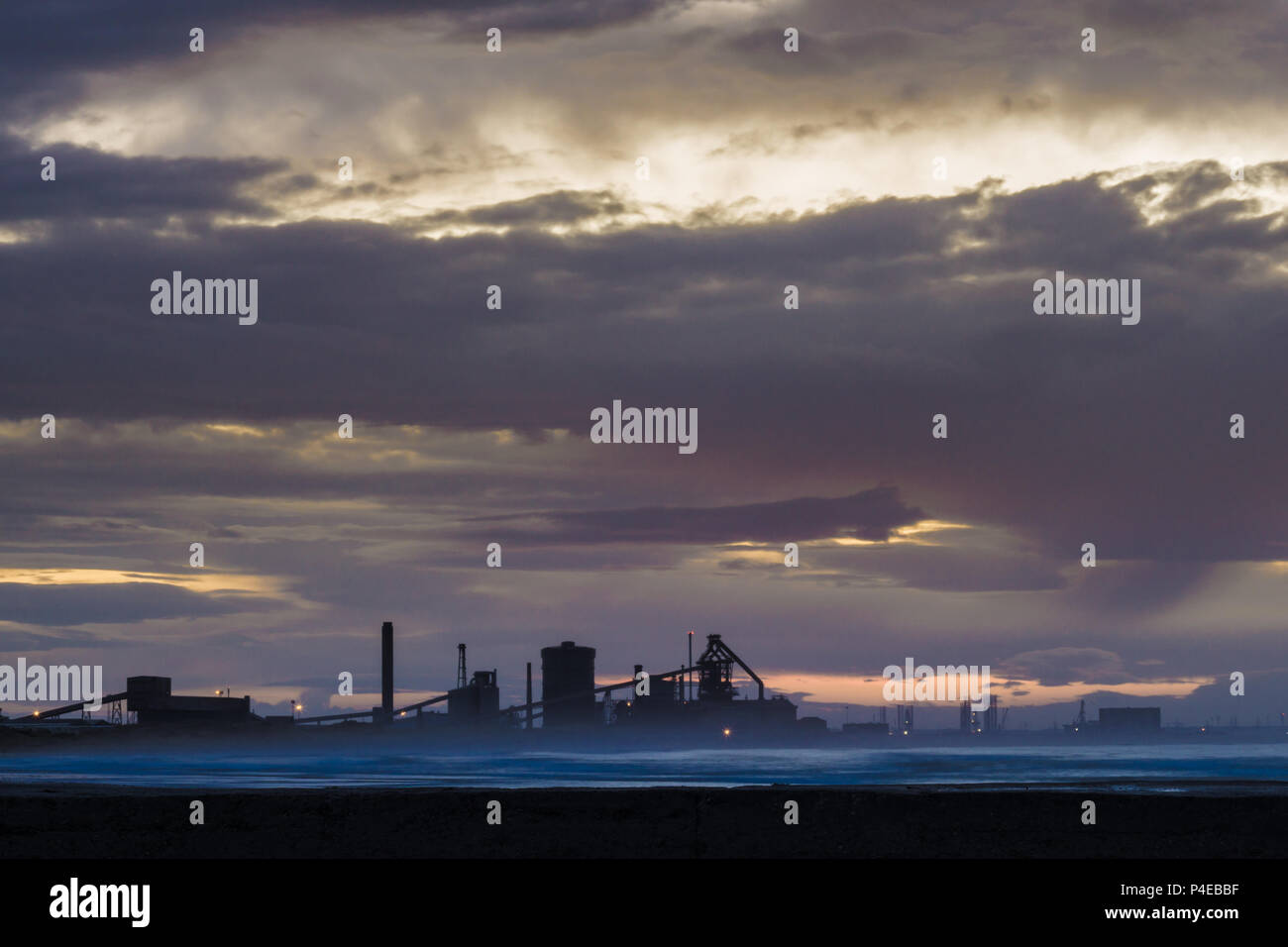 Redcar sunset with industrial background. Redcar is located on the north east coast of England. Stock Photo