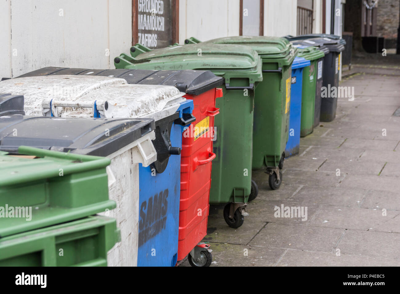 Collection of commercial wheelie bins / rubbish bins in Truro, Cornwall. Redundant data metaphor, commercial rubbish collection service. Stock Photo