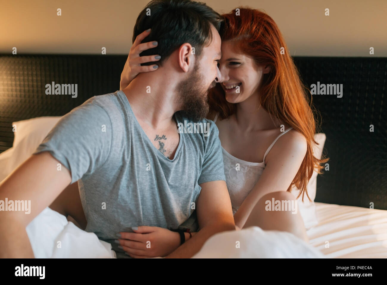 Tenderness od a beautiful couple in bedroom Stock Photo
