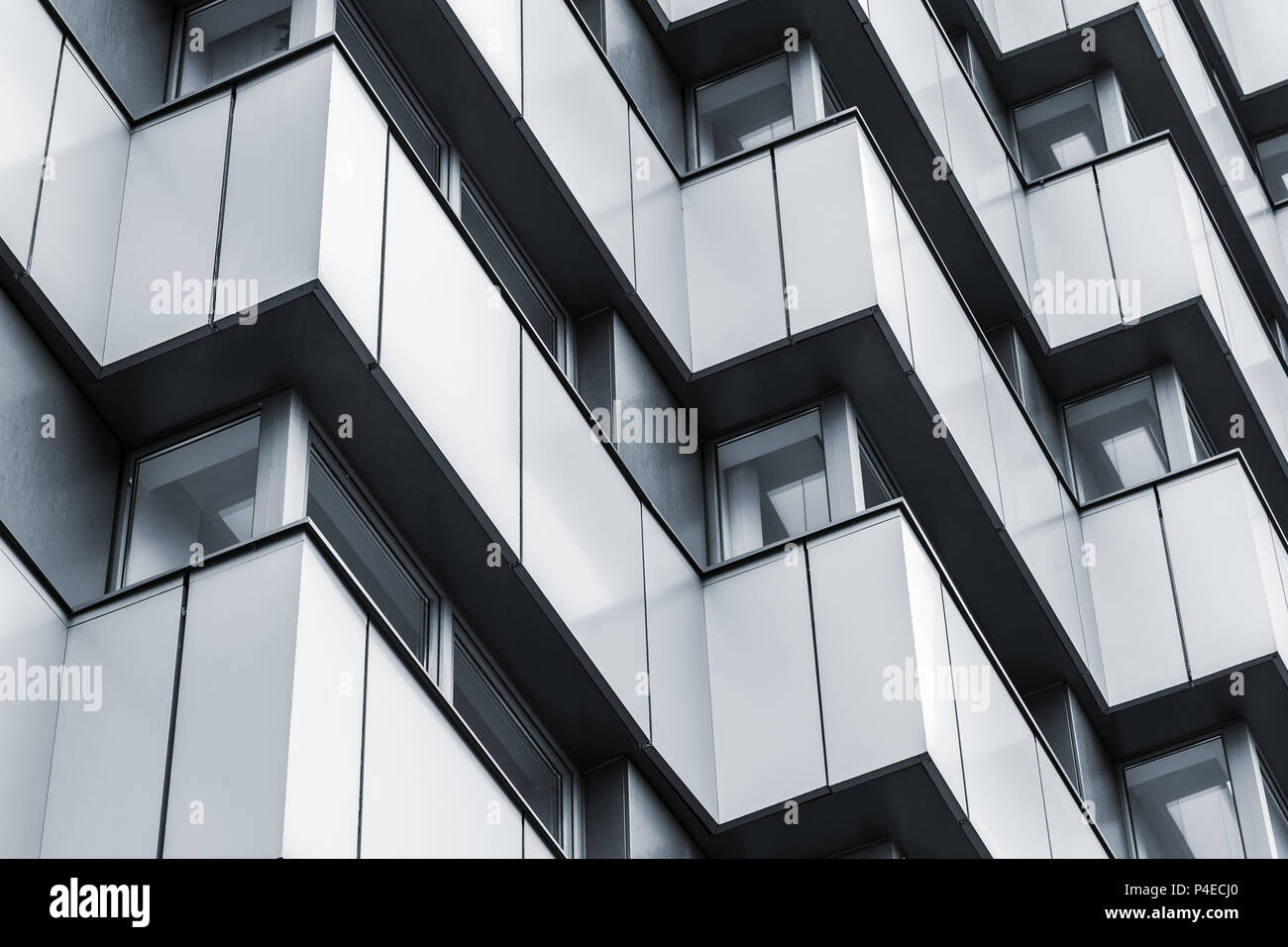 Abstract fragment of modern architecture, corners pattern, walls of steel with dark windows. Tonal filter effect Stock Photo