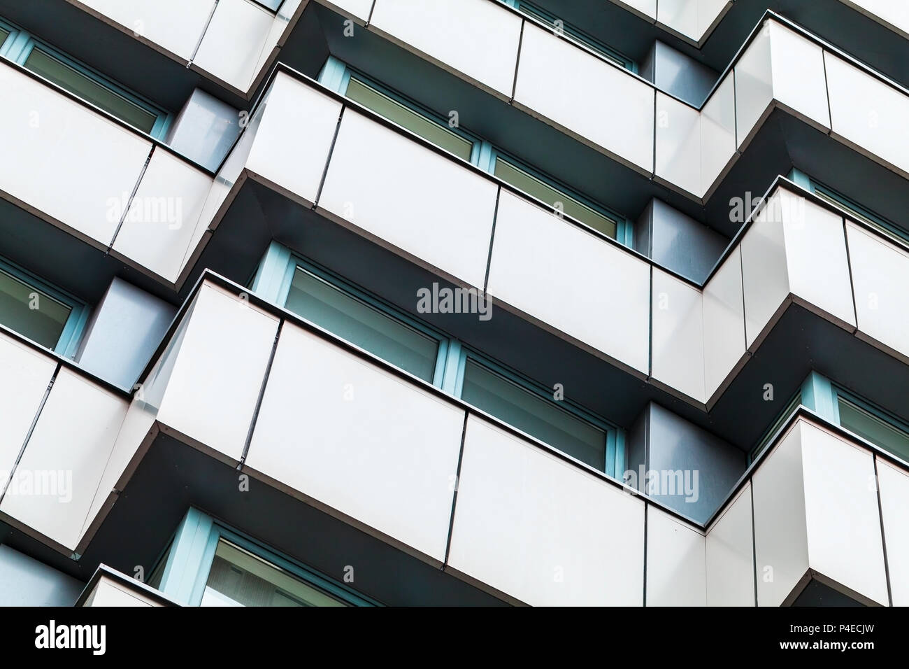Abstract fragment of modern architecture, corners pattern, walls of steel with dark windows Stock Photo