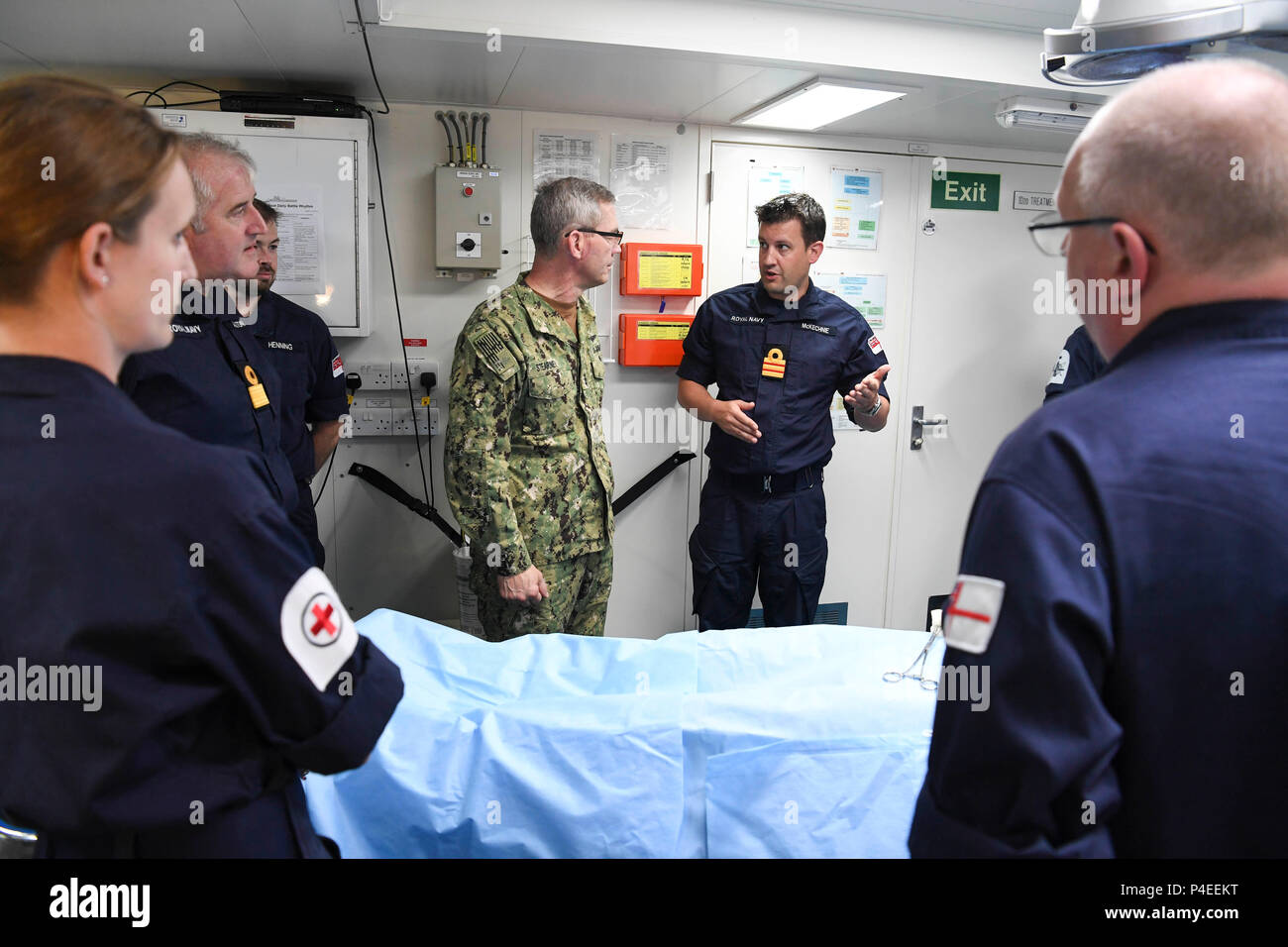 180617-N-TB177-0018 ARABIAN GULF (June 17, 2018) Vice Adm. Scott Stearney, commander of U.S. Naval Forces Central Command, U.S. 5th Fleet, Combined Maritime Forces, center, speaks with members of the Royal Navy aboard Royal Fleet Auxiliary ship Cardigan Bay during Mine Countermeasures Exercise (MCMEX) 18-2. The bilateral exercise enhances cooperation, mutual MCM capabilities and interoperability between the U.S. and U.K., demonstrating the shared commitment of ensuring unfettered operations of naval and support vessels, as well as commercial shipping movements, throughout the maritime domain.  Stock Photo