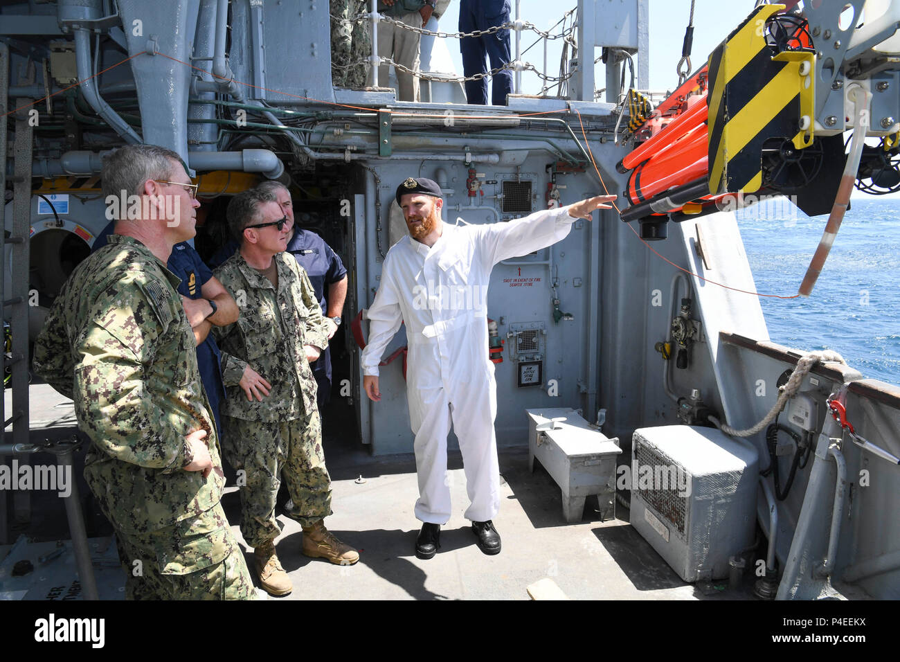 180617-N-TB177-0085 ARABIAN GULF (June 17, 2018) Lt. Tom Hasting, right, shows a Sea Fox inspection round to Vice Adm. Scott Stearney, commander of U.S. Naval Forces Central Command, U.S. 5th Fleet, Combined Maritime Forces, left, aboard HMS Middleton during Mine Countermeasures Exercise (MCMEX) 18-2. The bilateral exercise enhances cooperation, mutual MCM capabilities and interoperability between the U.S. and U.K., demonstrating the shared commitment of ensuring unfettered operations of naval and support vessels, as well as commercial shipping movements, throughout the maritime domain. (U.S.  Stock Photo