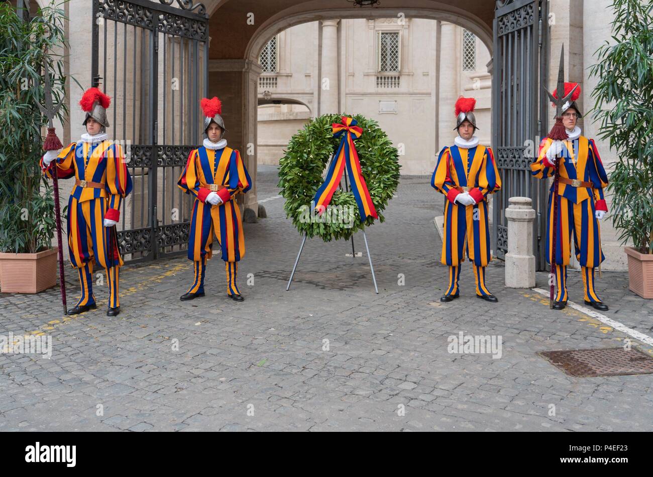 6 May 2018, Italia, Vatican: Guardsmen of the Pontifical Swiss Guard stand next to a wreath laid down every year at Campo Santo Teutonico in the Vatican in honor of the comrades who fell at the 'Sacco di Romai' in 1527. | usage worldwide Stock Photo