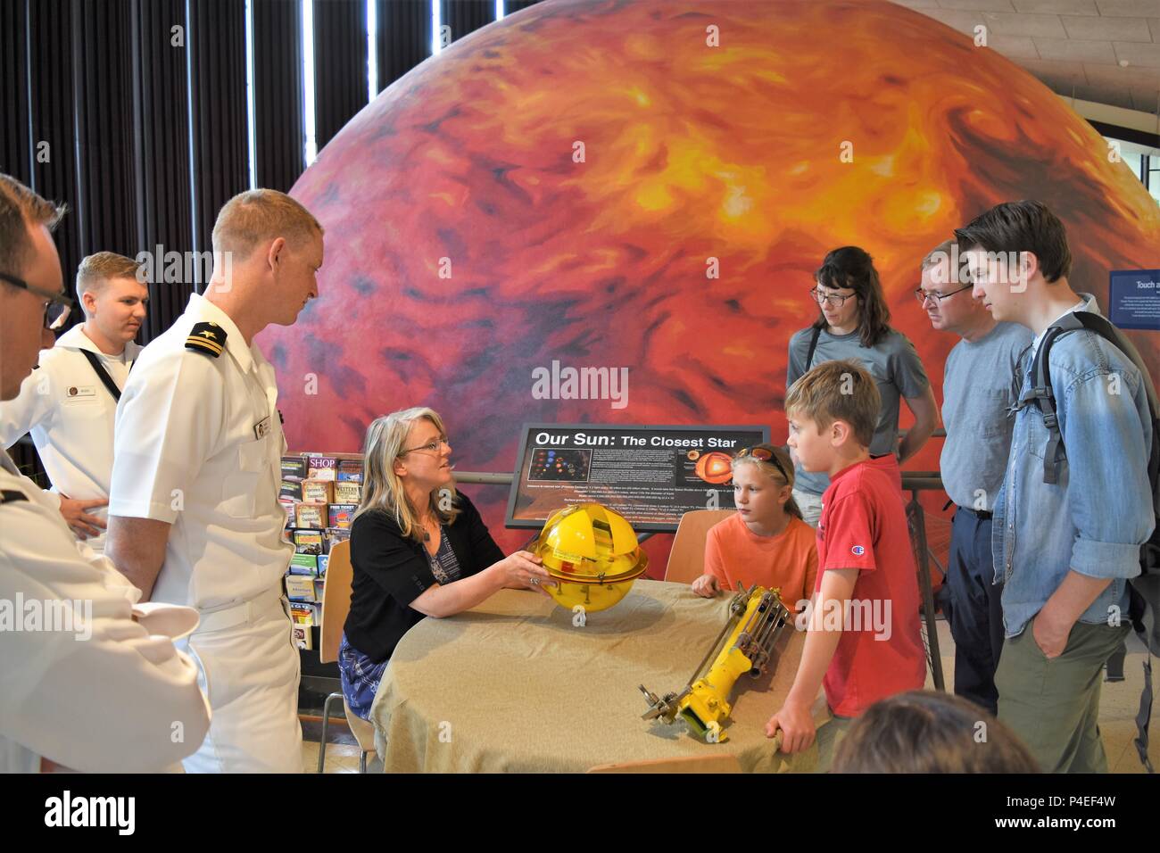 Phaedra Jessen, an oceanographer with Fleet Numerical Meteorological and Oceanographic Center, demonstrates a sensor buoy with visitors to University of Nevada – Reno’s Fleischmann Planetarium.  FNMOC is one of the many units in Reno for Navy Week.  Navy Week programs serve as the U.S. Navy's principal outreach effort into areas of the country that lack a significant Navy presence, helping Americans understand that their Navy is deployed around the world, around the clock, ready to defend America at all times. Stock Photo